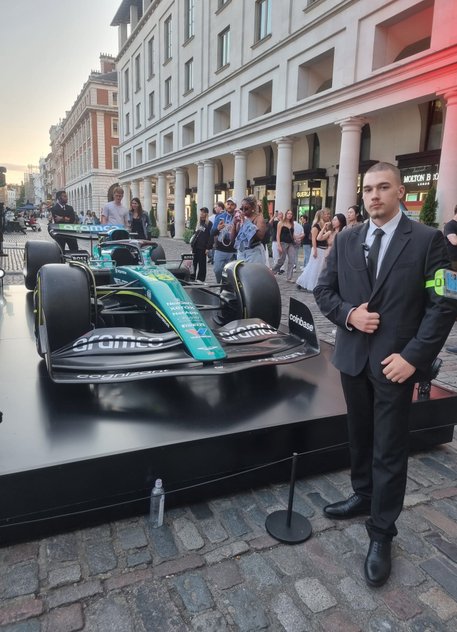 security guard in front of a racing car